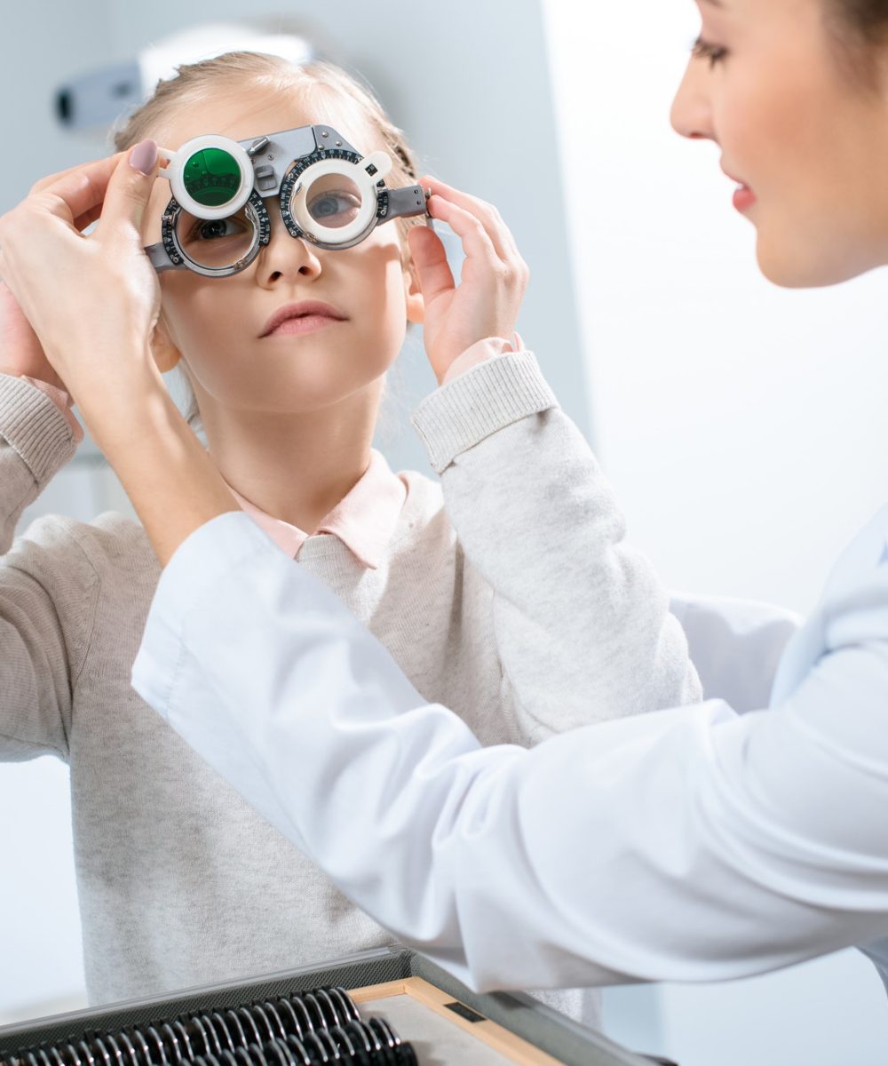 female-oculist-examining-kid-eyes-with-trial-frame-and-lenses.jpg